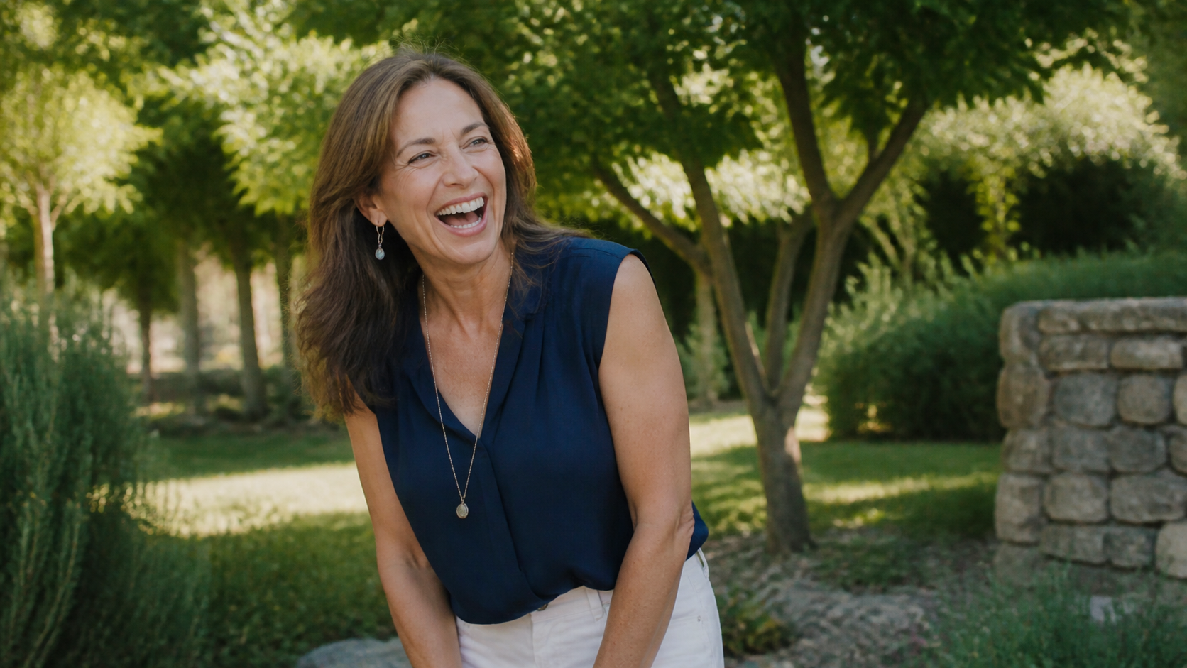 Joyful woman laughing outdoors in warm afternoon light
